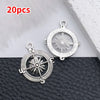 20 pieces of vintage ship anchor charms for jewelry making displayed on a dark surface.