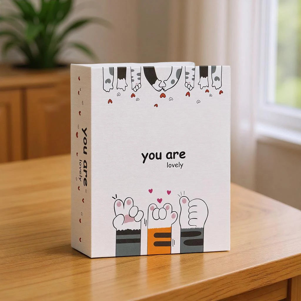 A white box featuring cartoon illustrations of hands and the text you are lovely for a photo album.