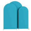 Three teal spandex fitted wedding arch covers standing upright.