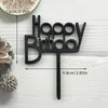 Black wooden birthday cake topper spelling out Happy Birthday