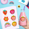 A hand holds a pink smoothie glass with a straw, surrounded by various colorful juice and dance themed stickers on a white sh