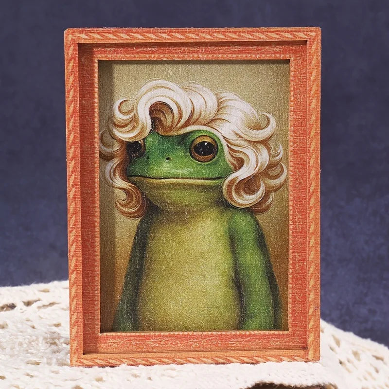 A painting of a green, curly-haired frog inside a wooden photo frame.
