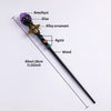 A crystal scepter featuring an amethyst gemstone, alloy ornament, and agate beads on a dark wand.