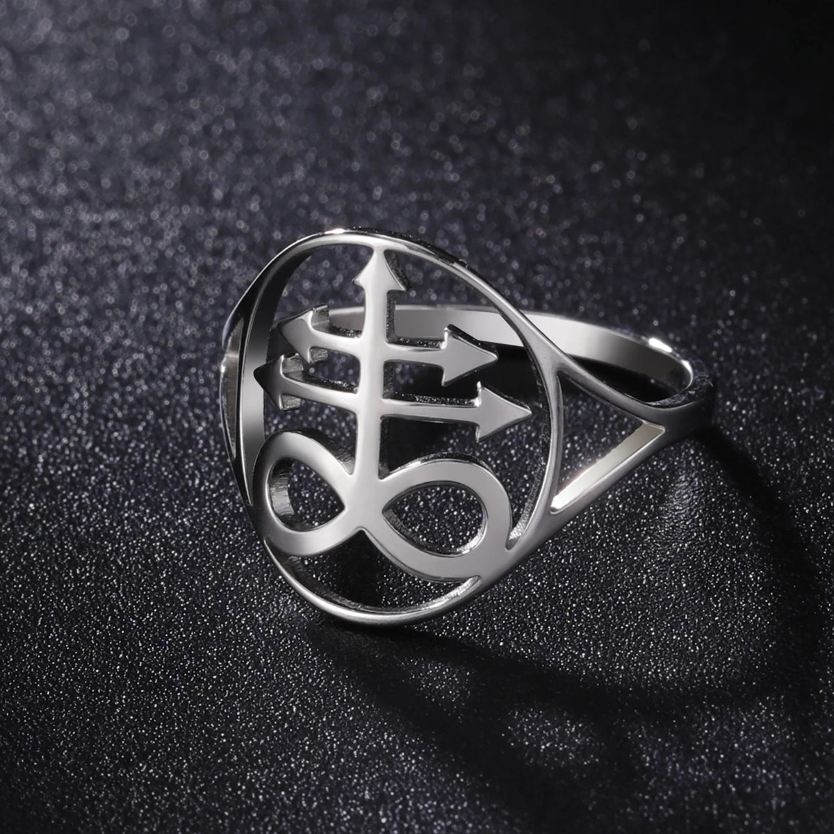 Silver signet ring featuring a stylized Leviathan cross design on a dark surface.