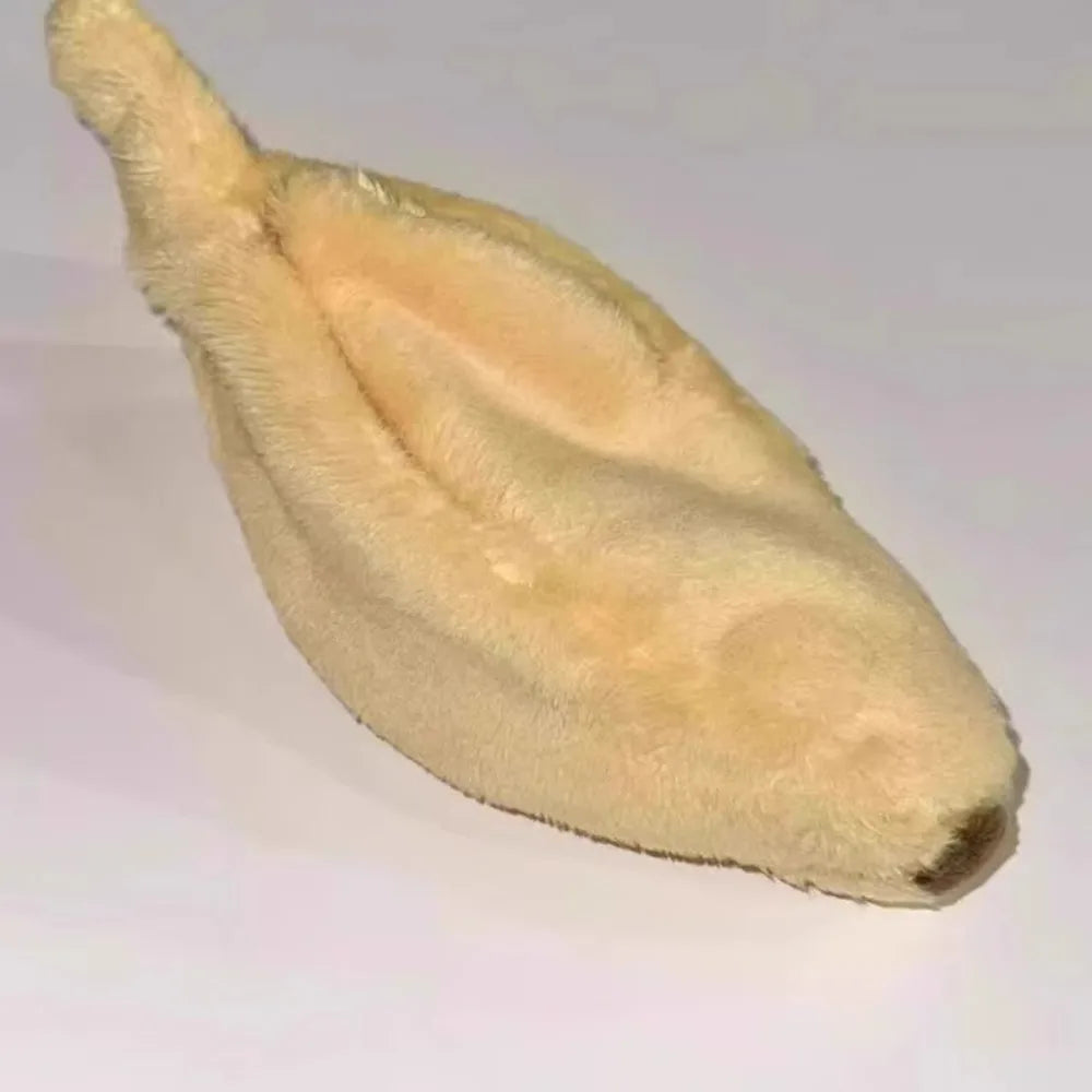 A light tan plush monkey toy with a soft, fuzzy texture.