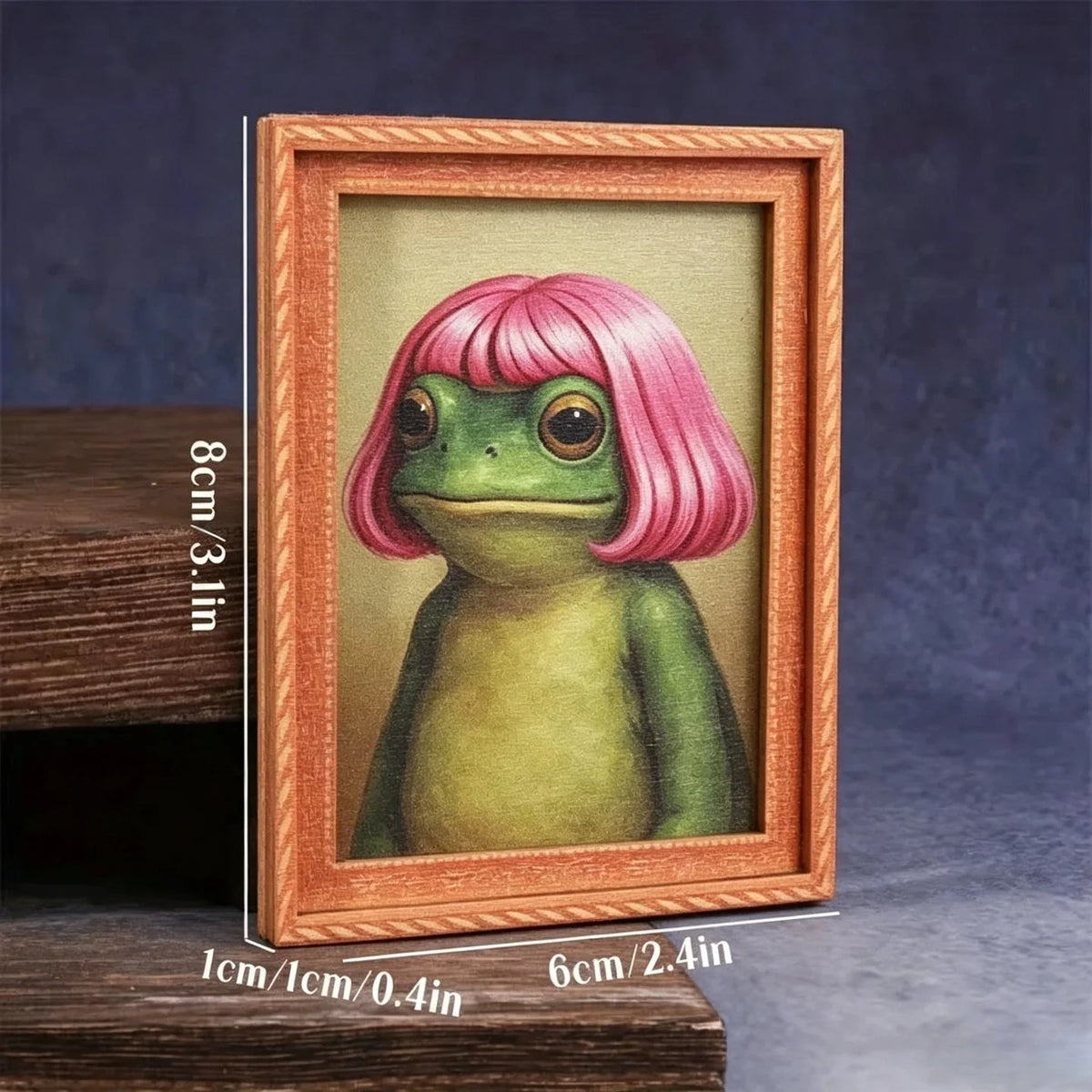 A wooden photo frame featuring a painting of a pink-haired green frog.