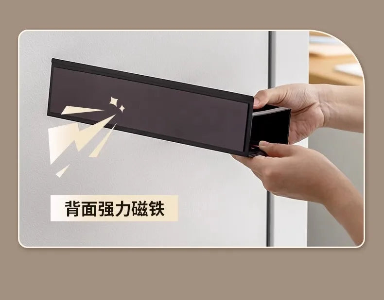 A hand holds a black magnetic spice rack designed for the refrigerator, demonstrating its strength.