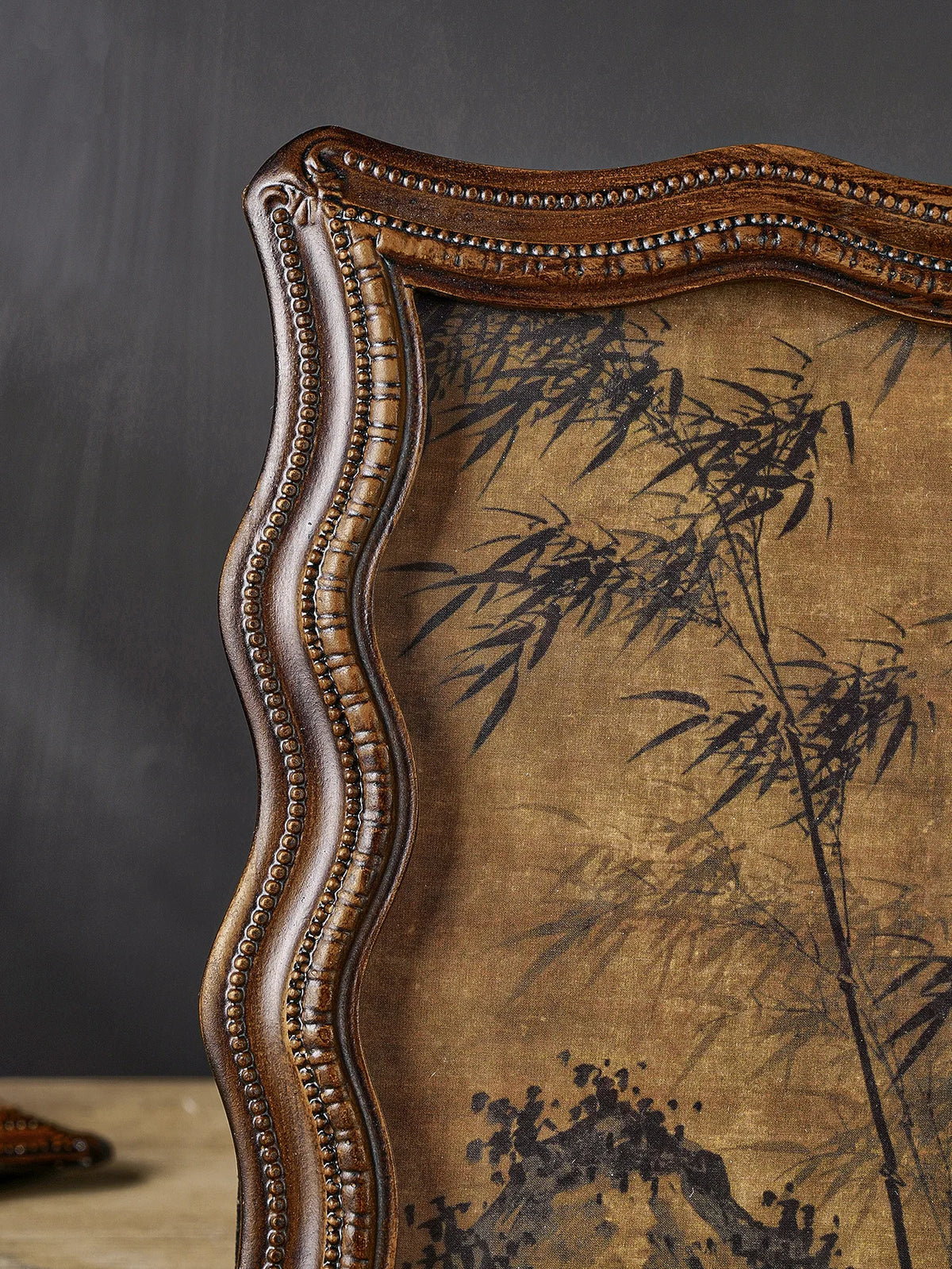 A vintage resin photo frame with a distressed gold-brown finish and dark botanical pattern.