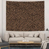 A large tapestry wall hanging featuring a brown and black leopard print on a beige wall above a light gray sofa.