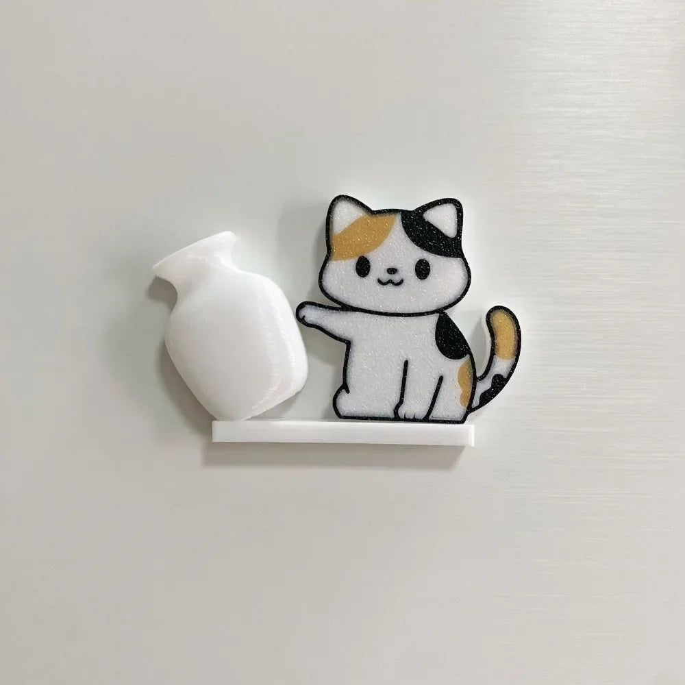 A white acrylic cat whiskered decor and a white bottle are mounted on a silver magnetic strip.