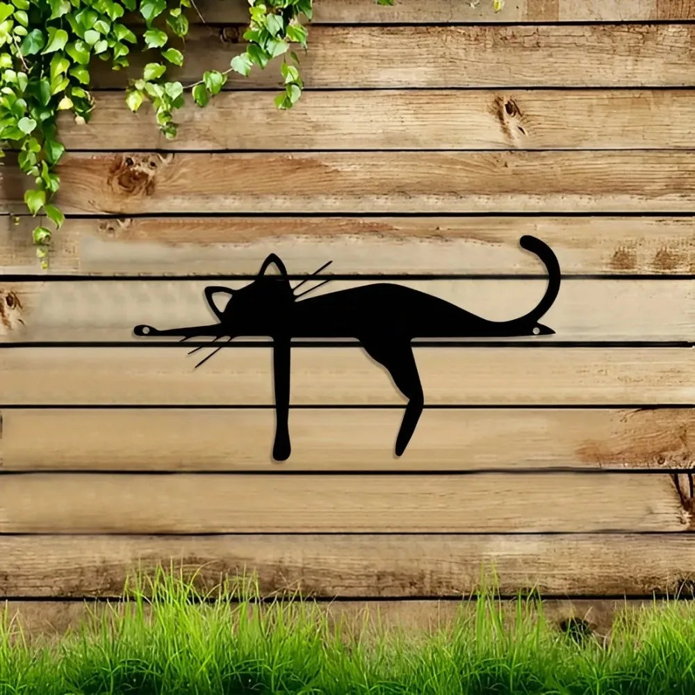 A silhouette of a cat is displayed on weathered wooden planks with green vines above and grass below.