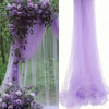 Purple sheer tulle draping fabric used as a wedding arch backdrop