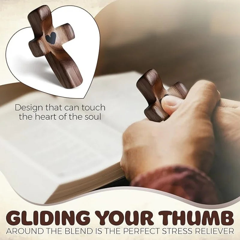 A hand gently touches a wooden comfort prayer cross on an open book, illustrating gliding your thumb around the blend as a st