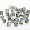 A collection of square cut glass crystal beads in various shades of blue and green.
