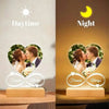 A custom acrylic heart photo frame displaying a couple kissing, set against a daytime and night theme.