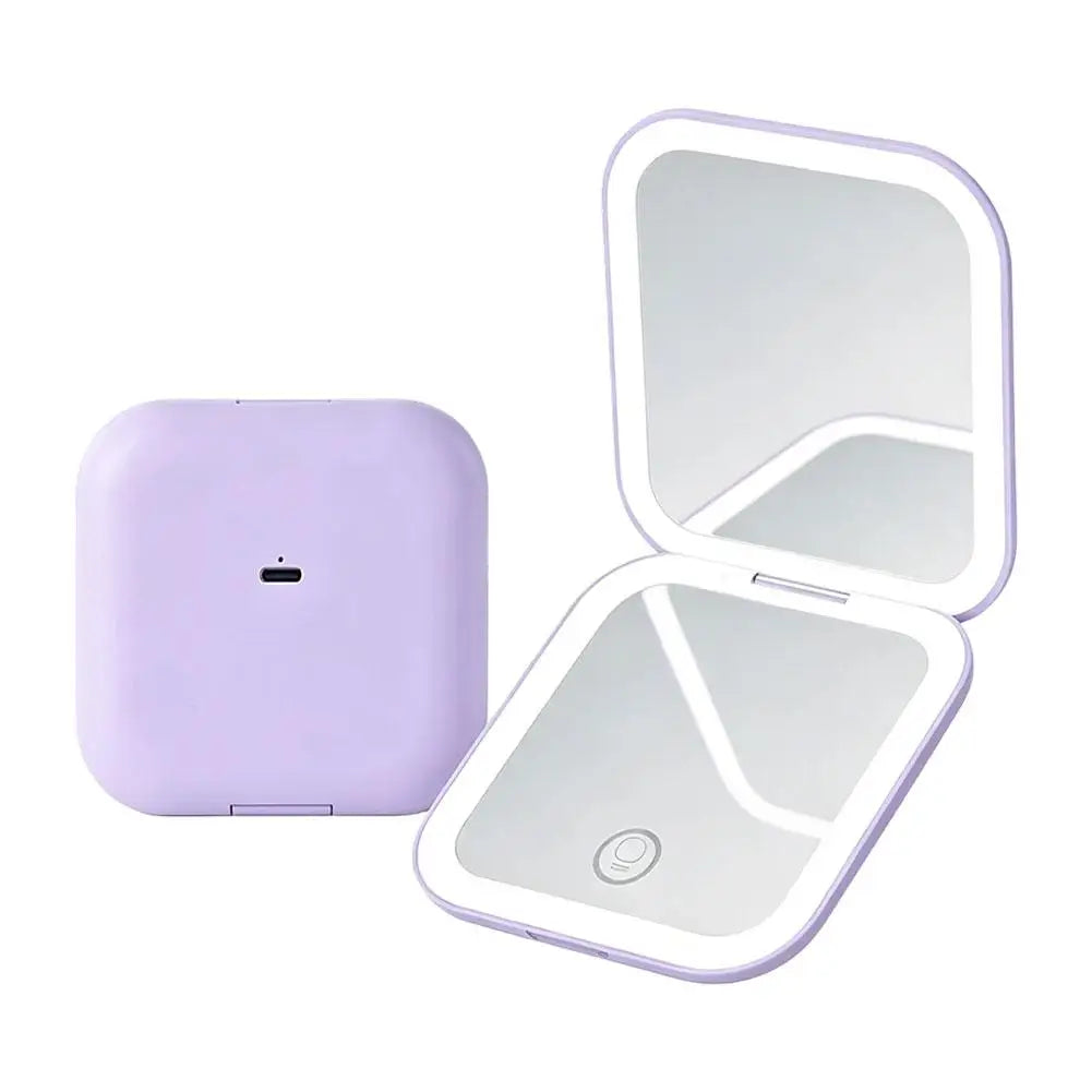 A purple portable folding LED makeup mirror with a reflective surface and a magnifying section.