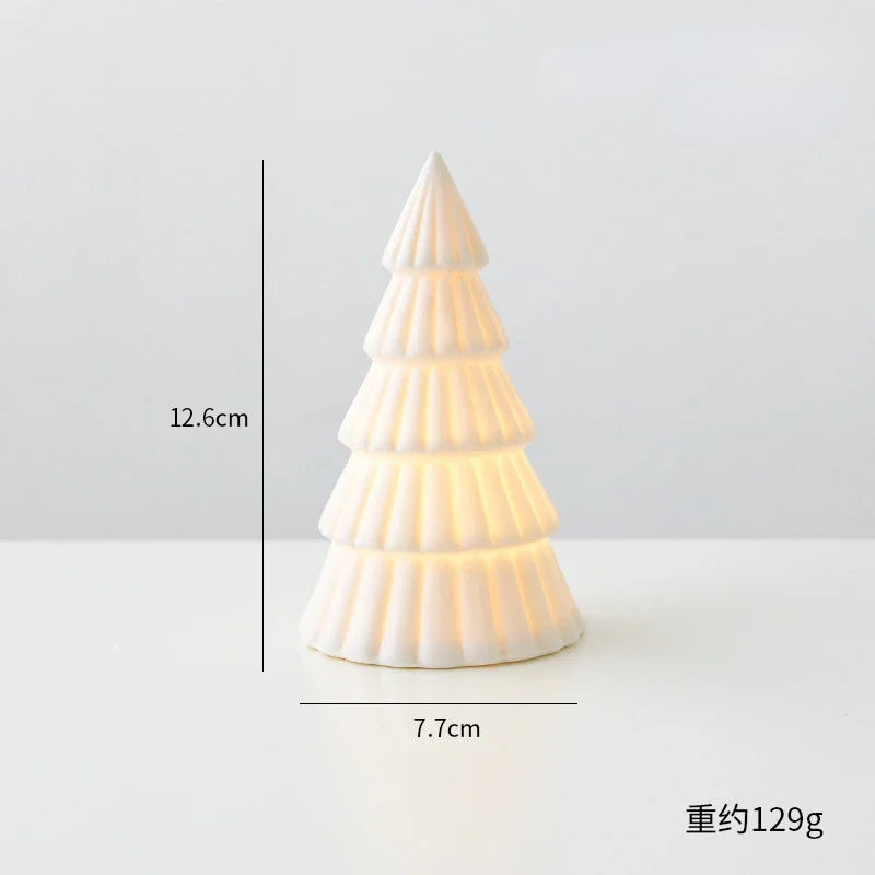 A white ceramic glow-in-the-dark mini Christmas tree decor shaped like a cone.