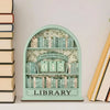 A light green wooden shelf displaying 45 books and a sign that reads Library