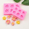 Pink silicone molds featuring floral patterns and yellow flowers for cake decorating
