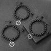 A set of black beaded bracelets and necklaces featuring zodiac symbols on silver charms