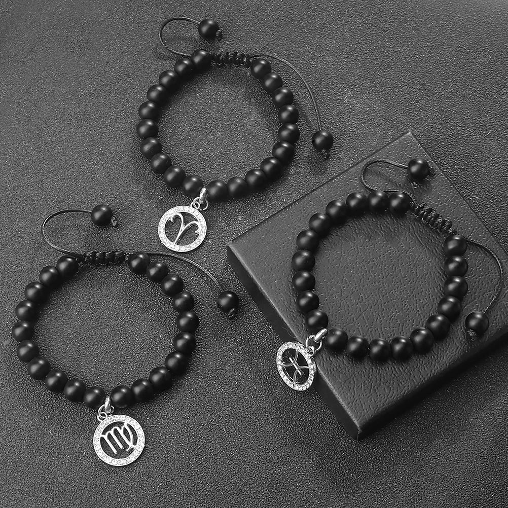 A set of black beaded bracelets and necklaces featuring zodiac symbols on silver charms