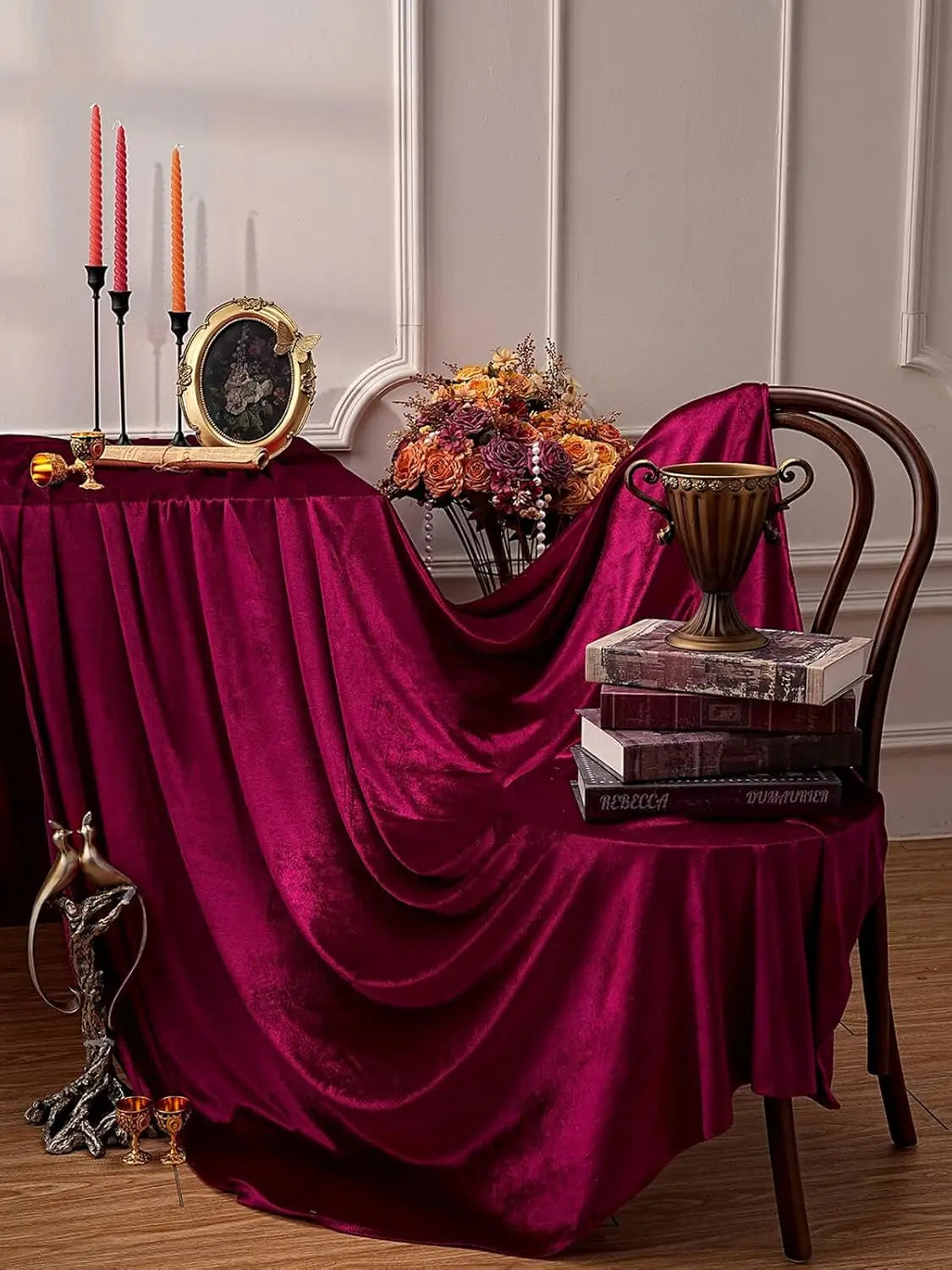 Burgundy red velvet rectangular tablecloth set for elegant dining featuring candelabras and decorative items
