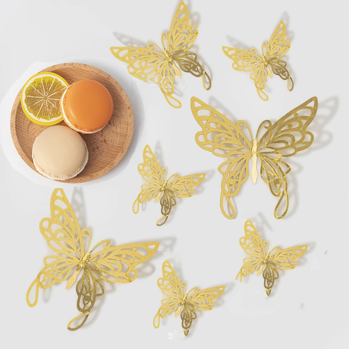 A set of three 3D gold butterfly wall decor pieces scattered on a white background.
