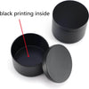 A black candle tin container with a lid, showing the inside of the tin.