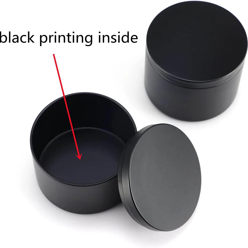 A black candle tin container with a lid, showing the inside of the tin.