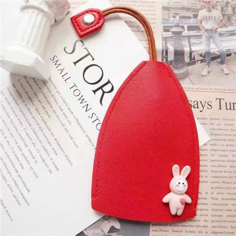A red cartoon PU leather key holder with a pull-out design is shown against a white background.