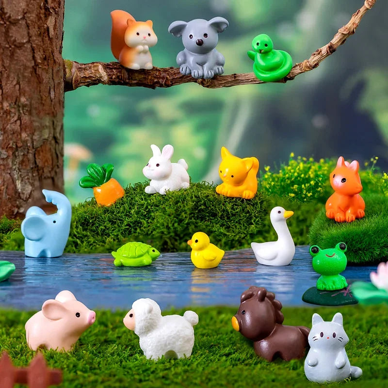 A collection of small, colorful animal figurines including a fox, bear, frog, and various mammals arranged in a green garden 