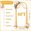 Gold metal arch backdrop stand for events featuring sheer pink fabric and floral decorations
