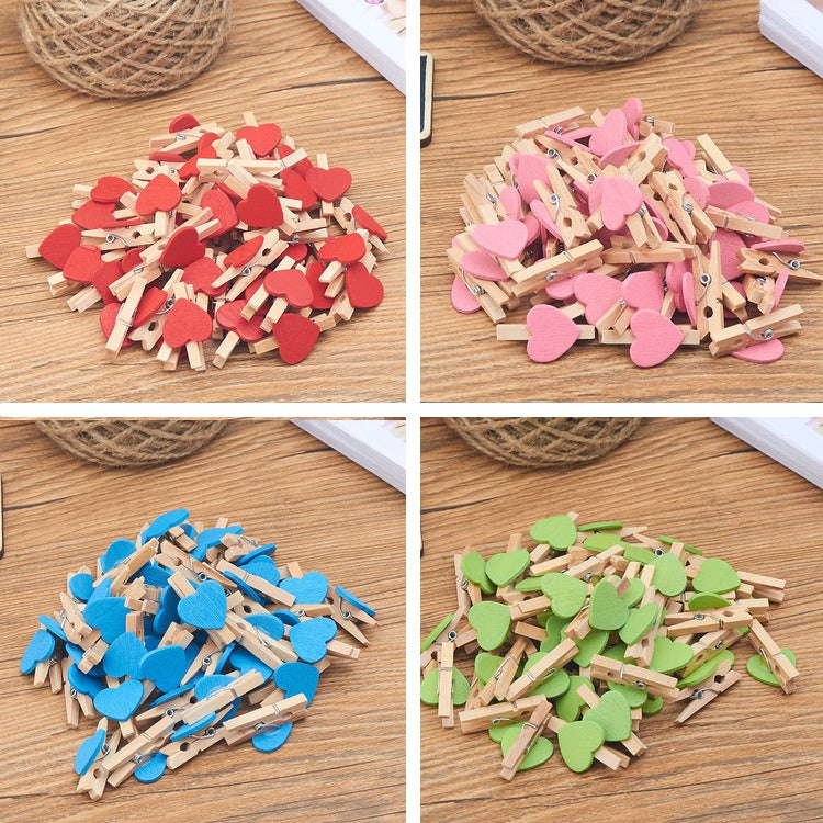 Assortment of mini wooden photo clips in various colors including red pink and green for crafts and display