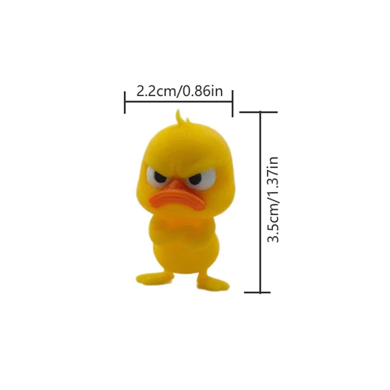 A yellow 3D printed statue of an angry duck with orange beak and eyes.