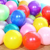 A collection of assorted latex balloons in various bright colors including pink, yellow, green, blue, and red.