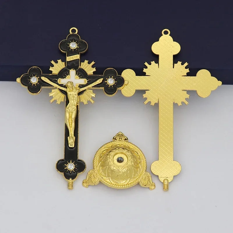 Antique-style crucifix figurine featuring a gold-colored cross and a decorative medallion on a dark background.