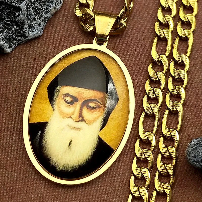 A gold-toned pendant featuring a portrait of Saint Charbel on a silver chain.