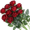A bouquet of deep red artificial roses with green leaves.