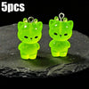 Five glow-in-the-dark green cartoon kitty duck resin charms displayed on a dark surface.