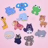 A collection of twelve soft pastel animal fridge magnets including elephants, a frog, a giraffe, and other cute creatures.
