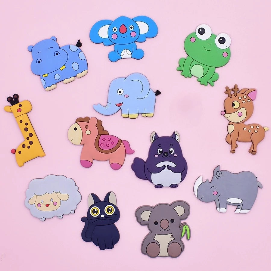 A collection of twelve soft pastel animal fridge magnets including elephants, a frog, a giraffe, and other cute creatures.
