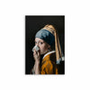 A portrait of a woman wearing a blue headscarf and an orange garment against a dark background.