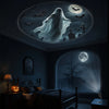 A dark bedroom ceiling features a glowing projection of bats and a ghostly figure against a moonlit night scene.
