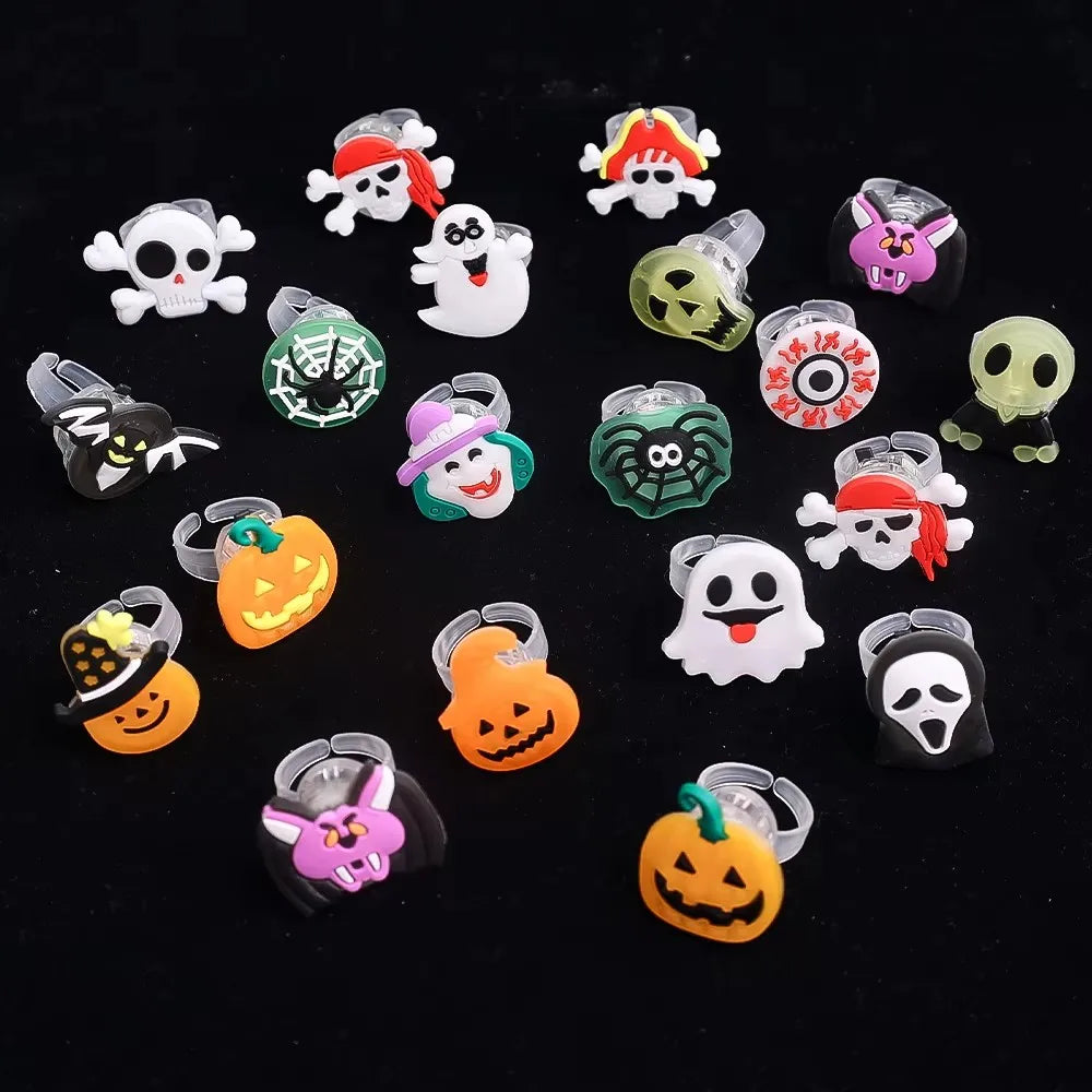 A collection of Halloween LED glow rings featuring designs of pumpkins, ghosts, and spiders.