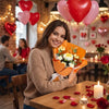 A smiling woman holds an orange bouquet of handmade crochet rose flowers on a wooden table.