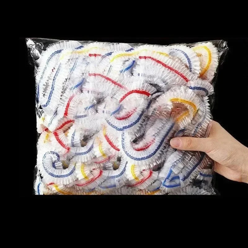 A clear plastic bag filled with numerous reusable elastic food covers or stretch bowl lids in various colors like white, blue