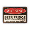 A vintage metal tin sign with a red oval warning and black text that reads WARNING BEER FRIDGE No food or other contaminants 