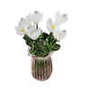 A bouquet of white tulips in a pink textured glass vase.