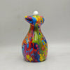 A colorful resin figurine of a frog with a large mouth and white eyes.