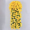 A vertical arrangement of bright yellow artificial violet ivy flowers used as a hanging garland.